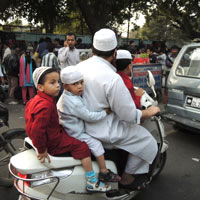 How many people can to cram onto a family scooter in Old Delhi?