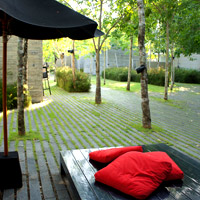 SALA Phuket features a minimalist grey zen design withg grass, gardens and flashes of crimson