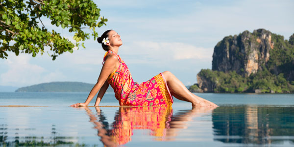 Beautiful Attractive Asian young woman practice Balancing stick Pose  stretching exercises muscle for warm up with sea,Feeling so comfortable and  relax in holiday Stock Photo