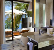 Airy bathrooms look out onto the pool area