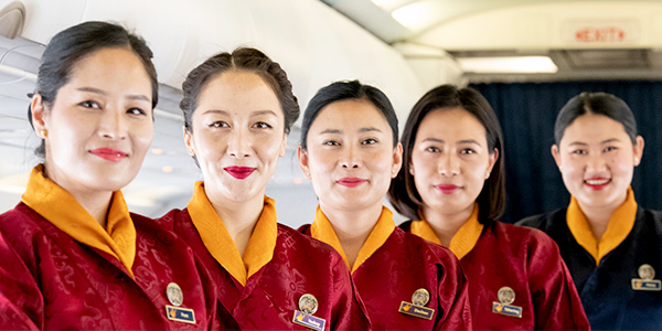 Bhutan Air crew welcome passengers to their A319 - fly direct HK to Paro